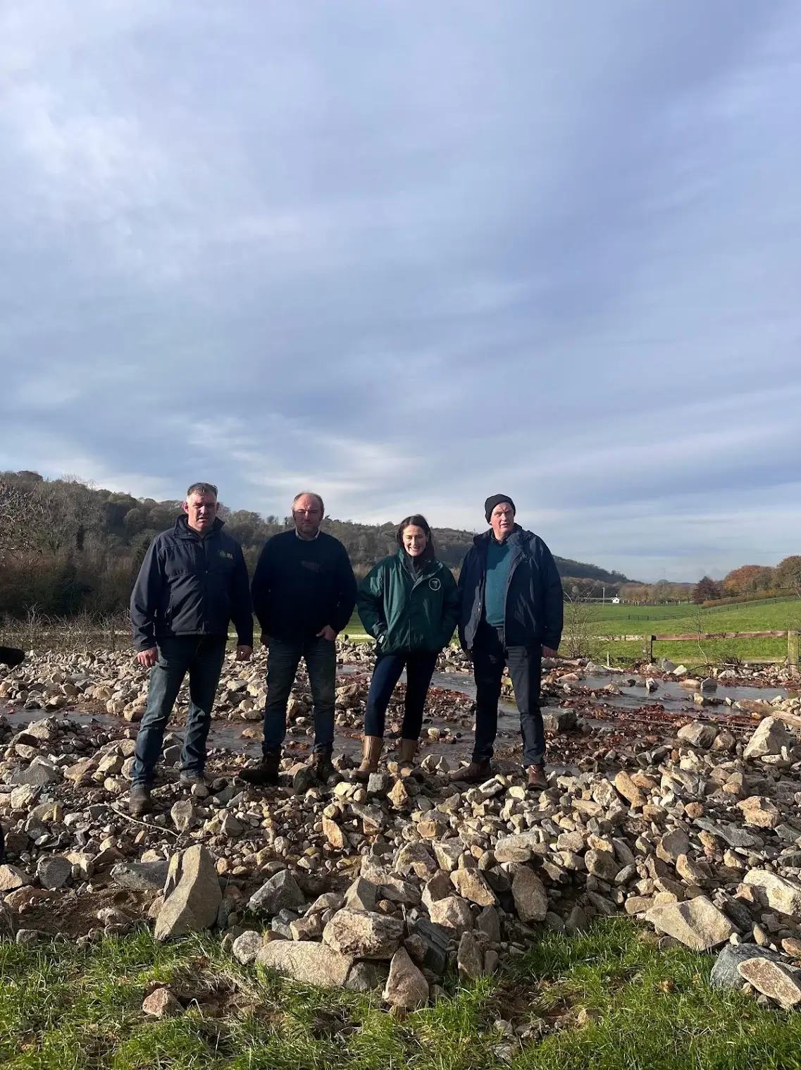 Senator Erin McGreehan with Irish Farmer Association Representatives in a field destroyed by floods.