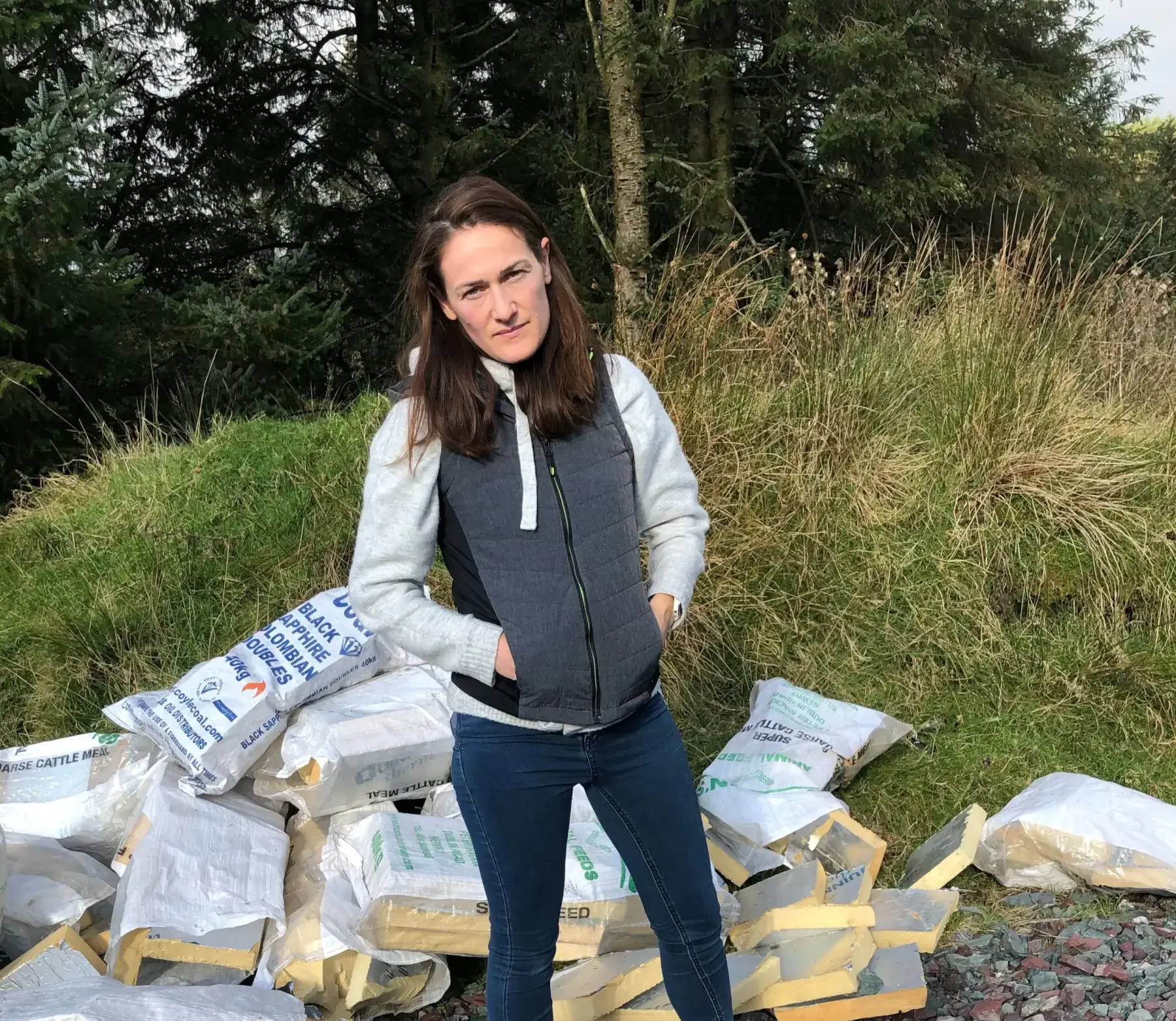 Erin standing beside dumped rubbish.