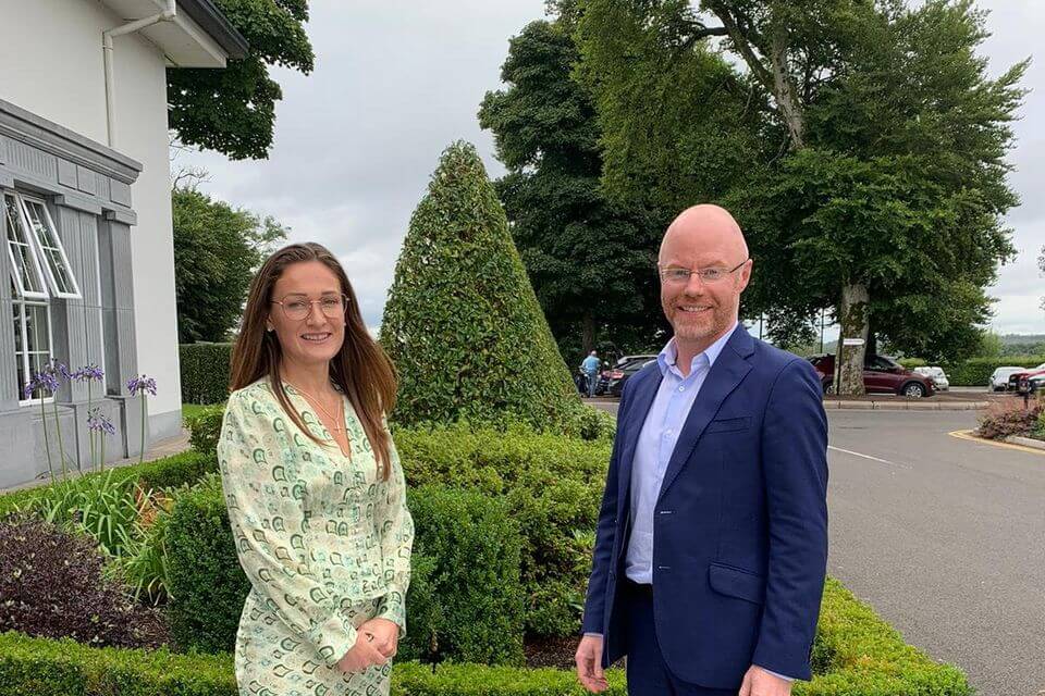 Senator Erin McGreehan standing to the left of Minister for Health Stephen Donnelly. Erin is wearing a light green patterned dress and Stephen Donnelly is wearing a navy suit and a light blue shirt.