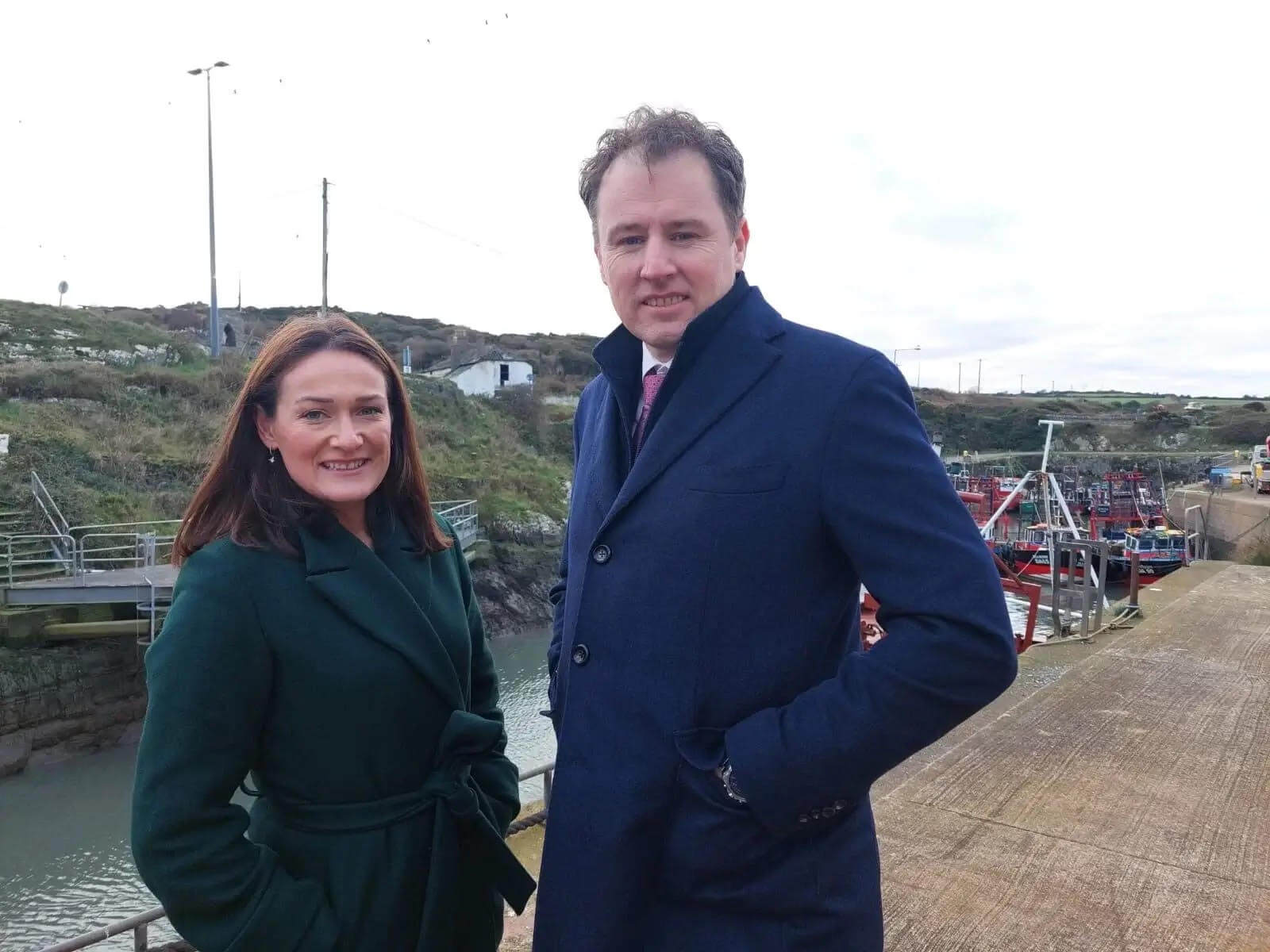 Picture of Senator Erin McGreehan wearing a dark green coat standing beside Minister for Agriculture Charlie McConalogue who is wearing a dark blue coat.